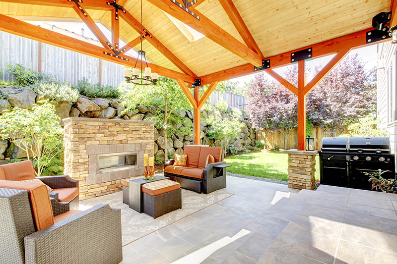 very nice backyard with a brick fireplace and seating around it
