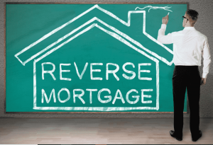 man writing on chalkboard the words reverse mortgage